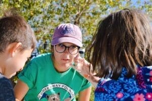 Greenway SPREE Staff examines river water sample with child
