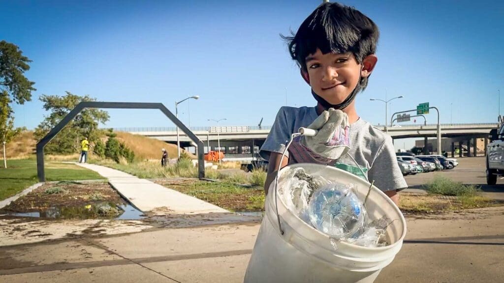 Child shows the litter collected at Fall Family Stewardship Day