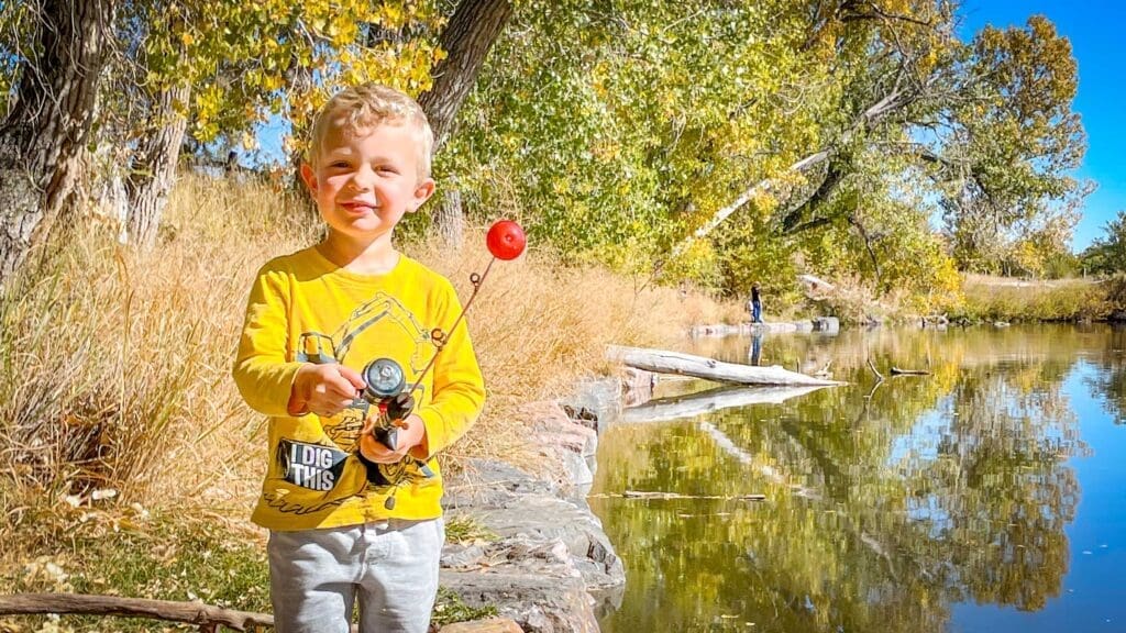 A proud child displays their fishing skill at Family Fishing Day.