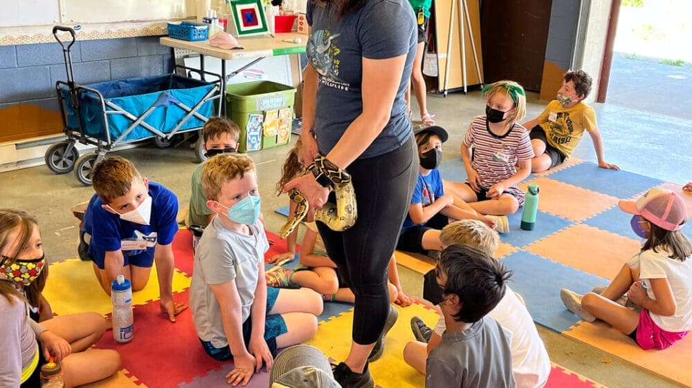 SPREE Campers meet a snake to learn about the river's ecosystem.