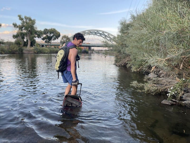 in stream trash pick up suitcase